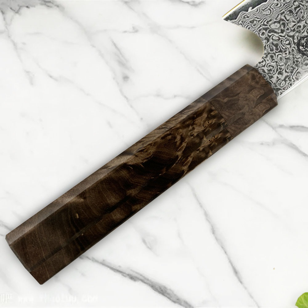 Kiritsuke Fossilwood knife on marble background, featuring a Damascus steel blade and a fossil wood handle.